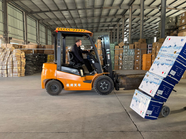 Pioneer Group team moving inspected boxes by forklift inside the warehouse