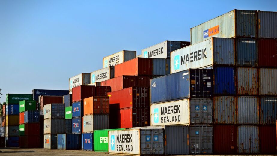 Stacked shipping containers at port, buying in bulk from China arrives by full container
