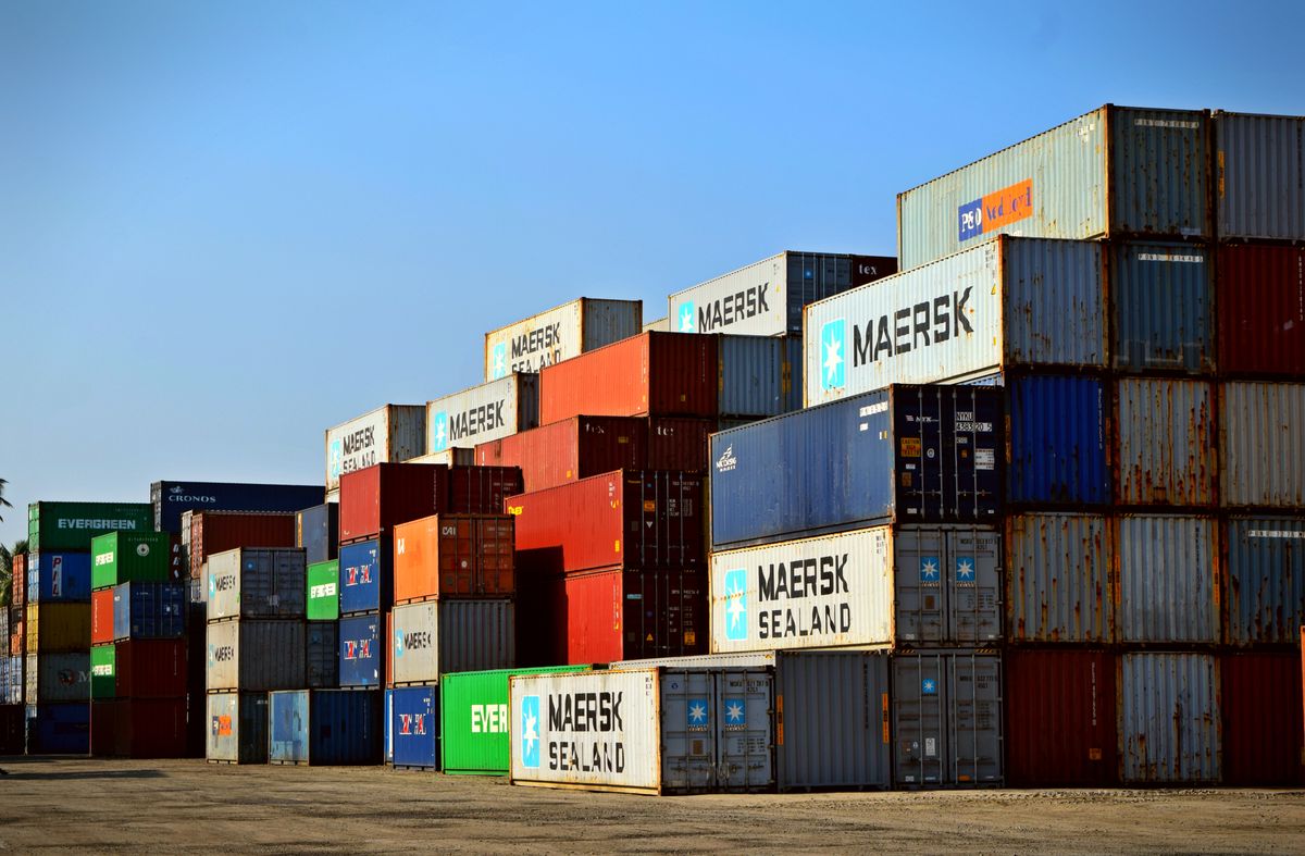 Stacked shipping containers at port, buying in bulk from China arrives by full container