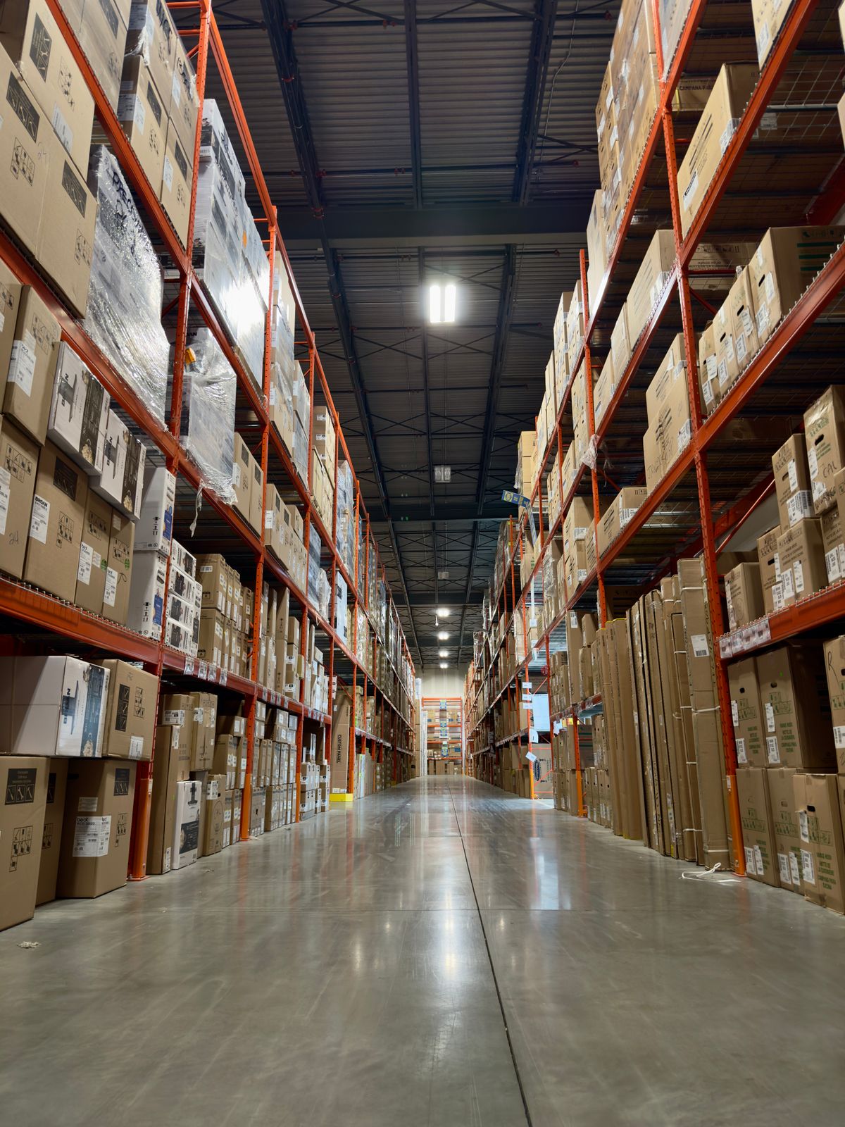 Warehouse aisle of boxed wholesale goods that Yiwu market buyers consolidate into one shipment