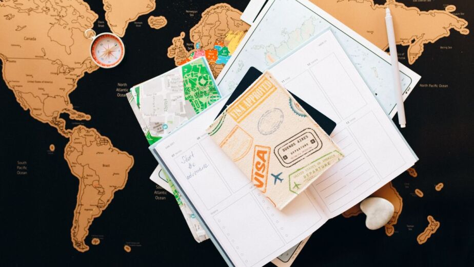Travel documents and planner on a world map for a Yiwu buying trip