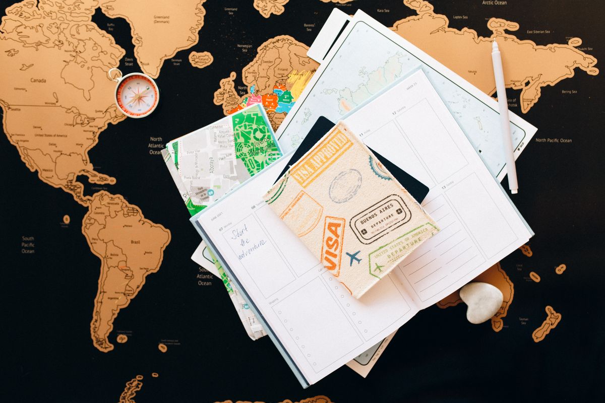 Travel documents and planner on a world map for a Yiwu buying trip
